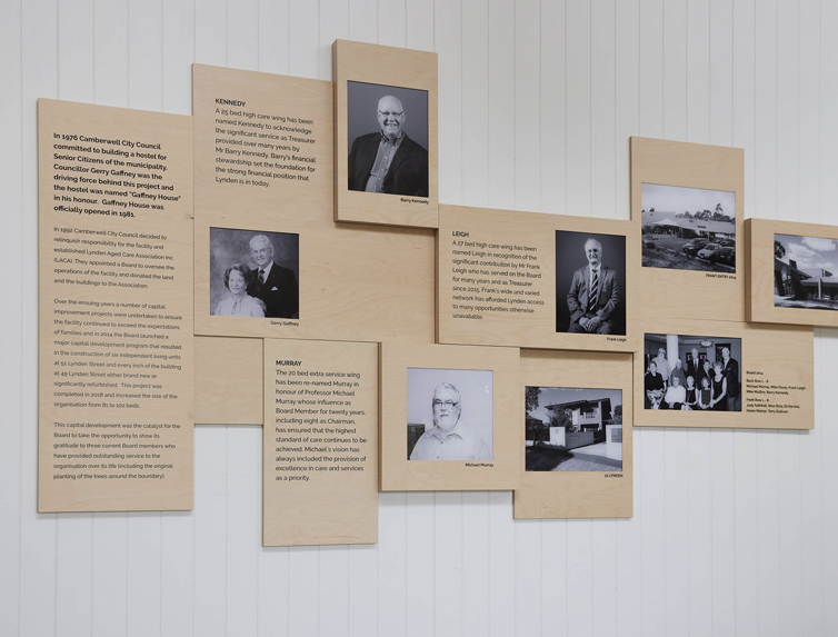 Modern wooden designed history wall with black and white images and text.